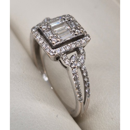 114A - 18ct white gold and diamond ring. 0.60cts. Round and emerald cut diamonds. Missing one round cut dia... 