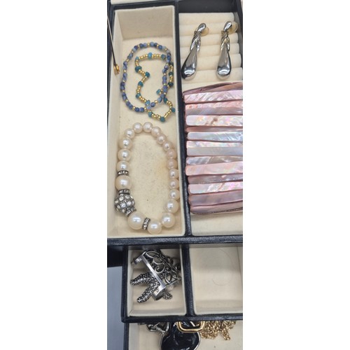 127A - Jewellery box containing a collection of costume jewellery rings, brooches and necklaces.