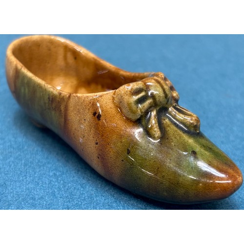 176 - Two pieces of 19th century Scottish Dunmore pottery; Peter Gardner resting plate and ladies shoe.