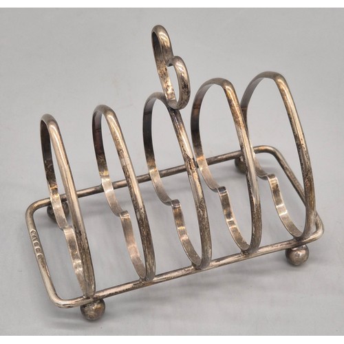 20 - Two Silver Marked Items; Birmingham silver heart shaped four slice toast rack and Weighted London Si... 