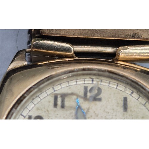 19 - 9ct yellow gold cased watch. Comes with elasticated plated strap. In a running condition. Damage to ... 