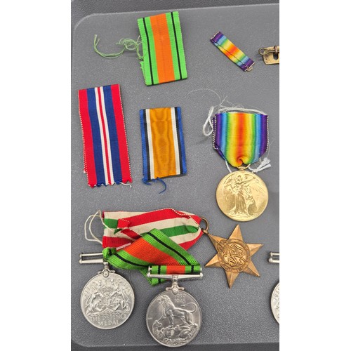 23 - A Selection of WWI & WW2 Medals, buttons and cap badges. Silver and enamel Scottish Rifle brooch. WW... 