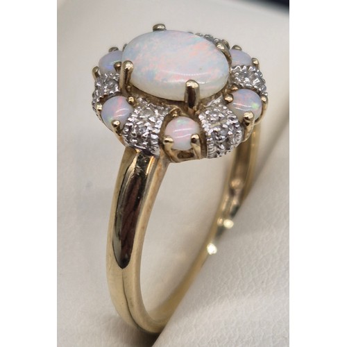 38 - 9ct yellow gold, Opal and diamond cluster ring. 2.90grams. Ring size T.
