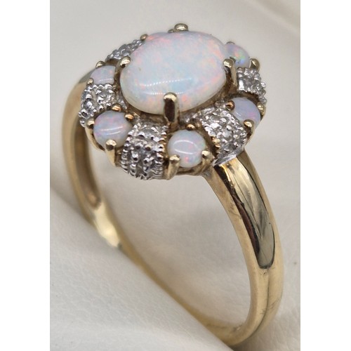 38 - 9ct yellow gold, Opal and diamond cluster ring. 2.90grams. Ring size T.