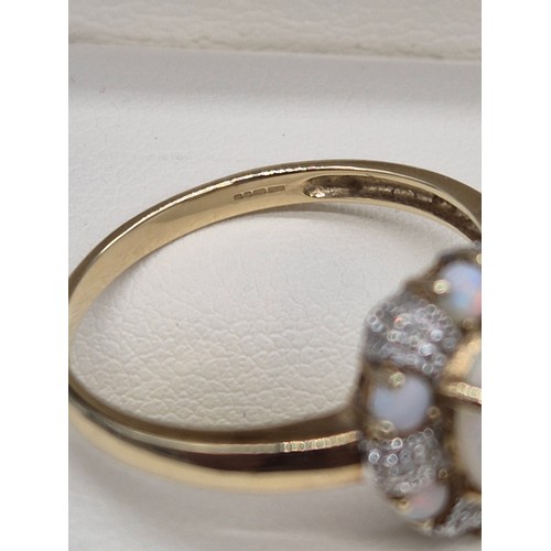 38 - 9ct yellow gold, Opal and diamond cluster ring. 2.90grams. Ring size T.