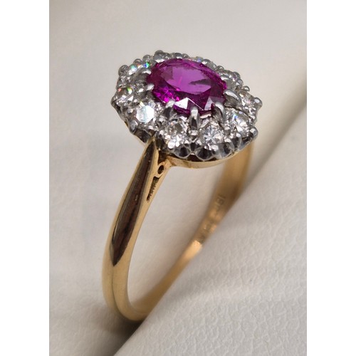 48 - 18ct & platinum, pink and diamond cluster ring. Oval form ruby/ pink sapphire, surrounded by round c... 