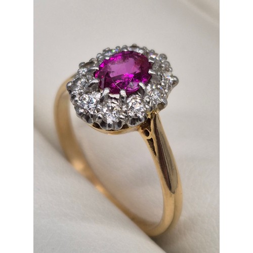 48 - 18ct & platinum, pink and diamond cluster ring. Oval form ruby/ pink sapphire, surrounded by round c... 