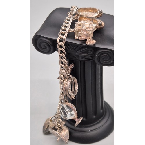 29 - Silver charm bracelet and charms. Together with silver chain and pendant.