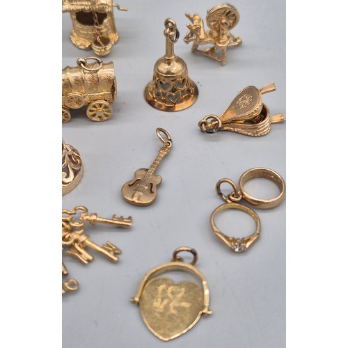 55 - A Collection of 9ct and 14ct yellow gold charms. One 14ct gold bell charm. The rest are 9ct gold- we... 