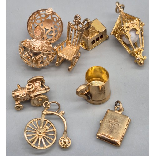 55 - A Collection of 9ct and 14ct yellow gold charms. One 14ct gold bell charm. The rest are 9ct gold- we... 