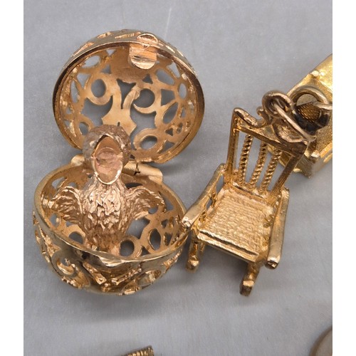 55 - A Collection of 9ct and 14ct yellow gold charms. One 14ct gold bell charm. The rest are 9ct gold- we... 