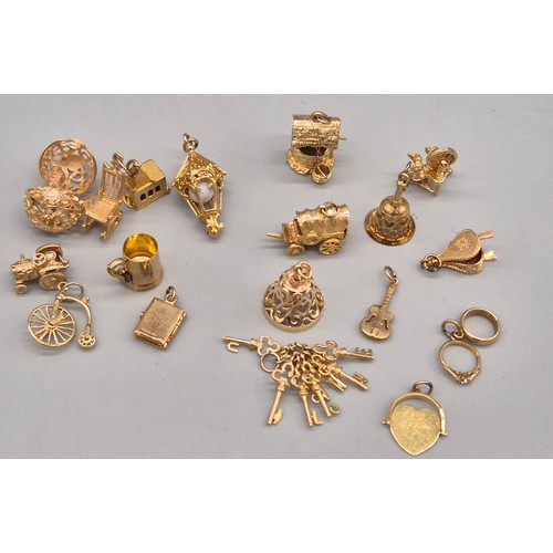 55 - A Collection of 9ct and 14ct yellow gold charms. One 14ct gold bell charm. The rest are 9ct gold- we... 