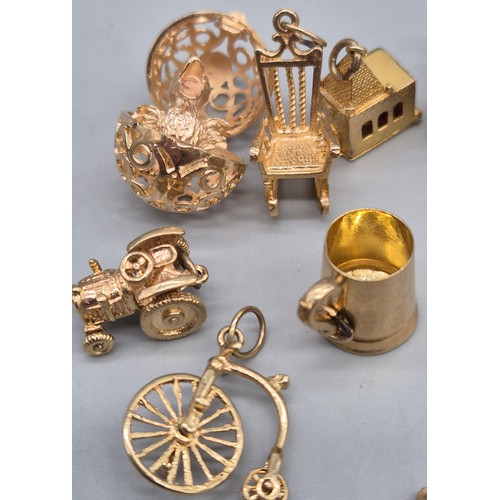 55 - A Collection of 9ct and 14ct yellow gold charms. One 14ct gold bell charm. The rest are 9ct gold- we... 