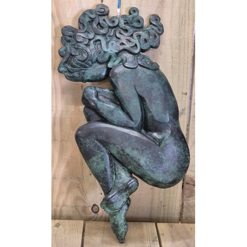 296 - Helen Dare
Bronze nude wall sculpture. 47cm length. Medusa style. Green patina finish.