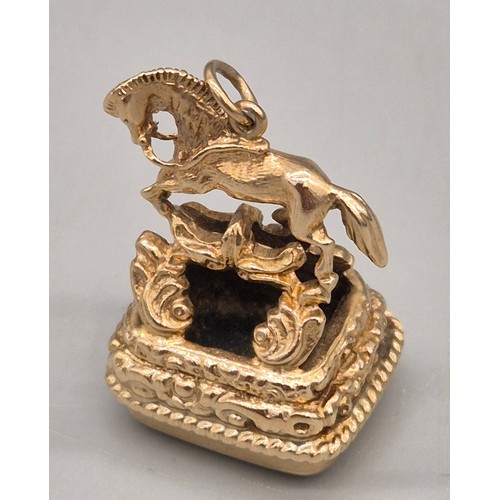 74 - 9ct yellow gold ornate horse figural fob seal. Blood stone. 15.47grams.