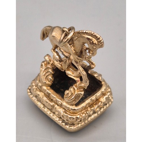 74 - 9ct yellow gold ornate horse figural fob seal. Blood stone. 15.47grams.