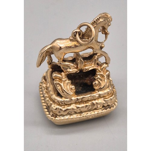 74 - 9ct yellow gold ornate horse figural fob seal. Blood stone. 15.47grams.