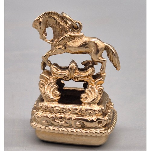 74 - 9ct yellow gold ornate horse figural fob seal. Blood stone. 15.47grams.