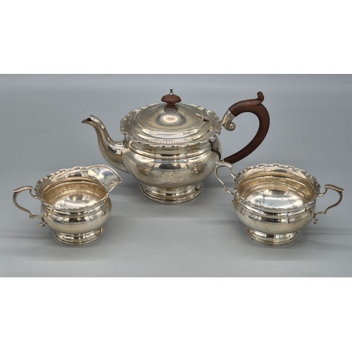 12 - Three piece Birmingham silver tea service. Tea pot, sugar and cream. Produced by Adie Brothers Ltd. ... 