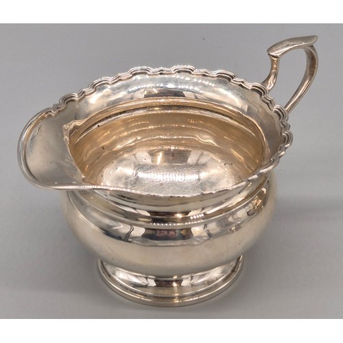 12 - Three piece Birmingham silver tea service. Tea pot, sugar and cream. Produced by Adie Brothers Ltd. ... 