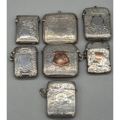 20 - A Collection of six Birmingham and one London Silver vesta cases. All ornately engraved and with som... 