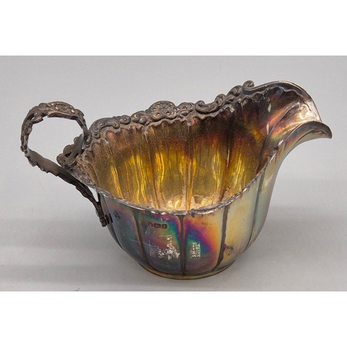 32 - Sheffield silver cream jug. Ornate handle and rim. Produced by Mappin Brothers. 83grams.