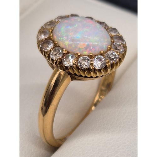 38 - 18ct yellow gold, Opal and diamond stone ring. Cabochon form opal centre stone surrounded by round c... 