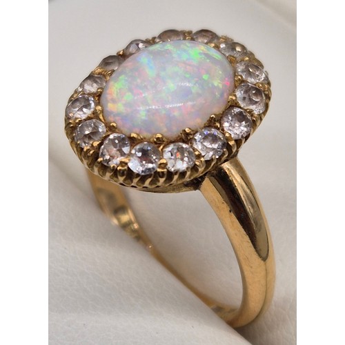 38 - 18ct yellow gold, Opal and diamond stone ring. Cabochon form opal centre stone surrounded by round c... 