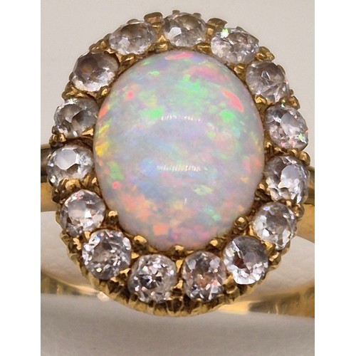 38 - 18ct yellow gold, Opal and diamond stone ring. Cabochon form opal centre stone surrounded by round c... 