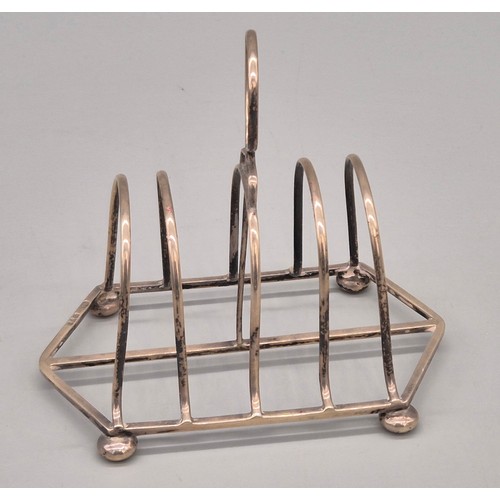 49 - A Selection of silver wares; Chester silver four slice toast rack- produced by Nathan & Hayes. Birmi... 
