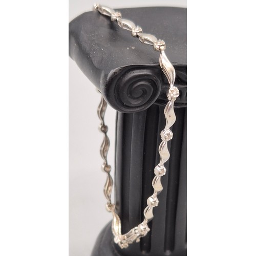30 - 9ct white gold and diamond ladies bracelet. Round cut diamonds. 4.53grams. 19cm length.