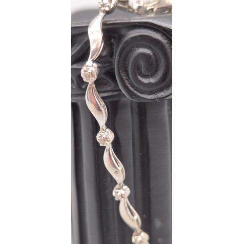 30 - 9ct white gold and diamond ladies bracelet. Round cut diamonds. 4.53grams. 19cm length.