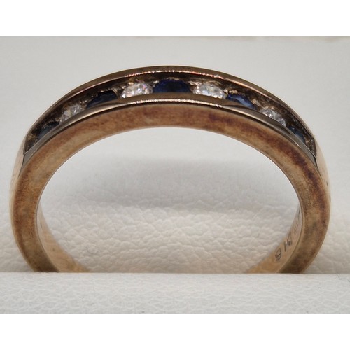 57 - 9ct yellow gold, blue topaz and diamond stone band ring. Round cut blue topaz and diamonds. 0.15cts.... 