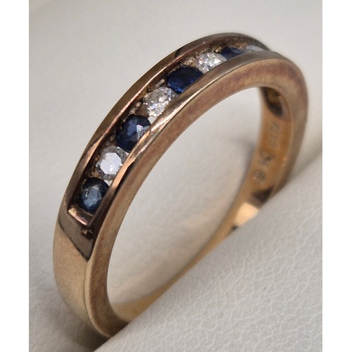 57 - 9ct yellow gold, blue topaz and diamond stone band ring. Round cut blue topaz and diamonds. 0.15cts.... 