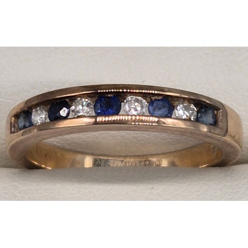 57 - 9ct yellow gold, blue topaz and diamond stone band ring. Round cut blue topaz and diamonds. 0.15cts.... 