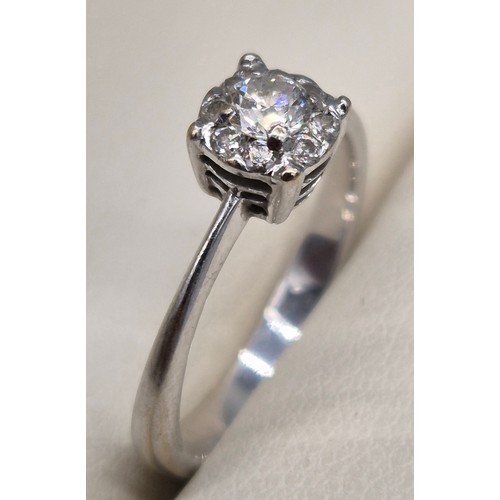 55 - 9ct white gold and diamond stone ring. 0.30cts. Round cut centre diamond surrounded by eight smaller... 