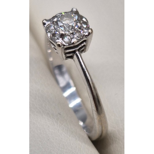55 - 9ct white gold and diamond stone ring. 0.30cts. Round cut centre diamond surrounded by eight smaller... 