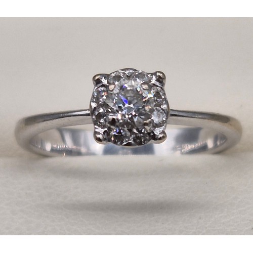 55 - 9ct white gold and diamond stone ring. 0.30cts. Round cut centre diamond surrounded by eight smaller... 
