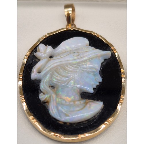 60 - 14ct yellow gold, onyx and Australian opal gem stone cameo carved pendant.