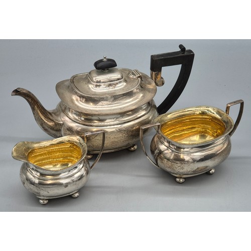 50 - Three piece Birmingham silver tea service. Produced by Hemming & Walton. Tea pot fitted with a woode... 