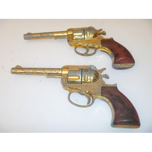 142 - pair of frontier ace lone star / crescent style cap guns , unchecked, with playwear and faults