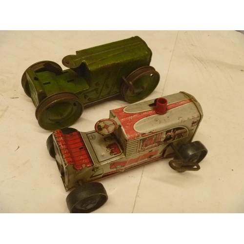 163 - 2 TINPLATE CLOCKWORK TRACTORS BY MARX, MOTORS RUN BUT WHEELS DO NOT ENGAGE PROPERLY AND SLIP