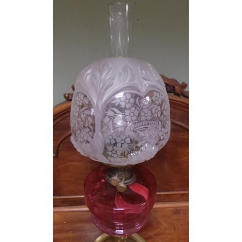 292 - Antique Brass Based Oil Lamp with Cranberry Glass Reservoir and pink etched glass shade  (64cm high)