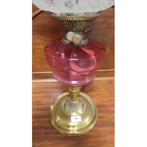 292 - Antique Brass Based Oil Lamp with Cranberry Glass Reservoir and pink etched glass shade  (64cm high)