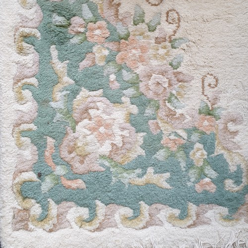 16 - Chinese embossed green and cream floor rug, Length 220cm x Width 120cm