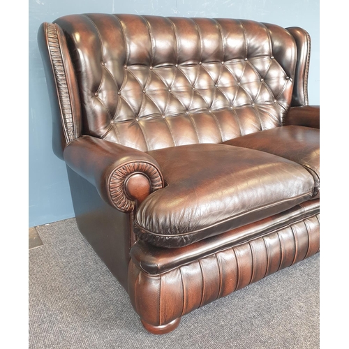 79 - Brown Leatherette Wingback Two Seater Sofa. Length 130cm, Depth 90cm, Seat Height 40cm approx.