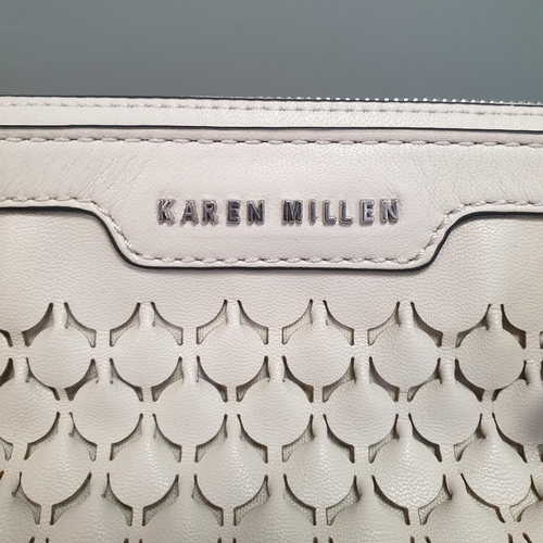 587 - A Karen Miller Designer Cream Leather Handbag with Protective Bag