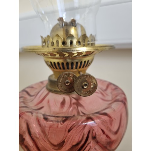 743 - Antique Brass Oil Lamp with Ruby Reservoir and Funnell, Height 70cm