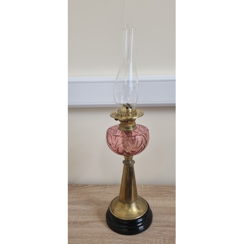 743 - Antique Brass Oil Lamp with Ruby Reservoir and Funnell, Height 70cm