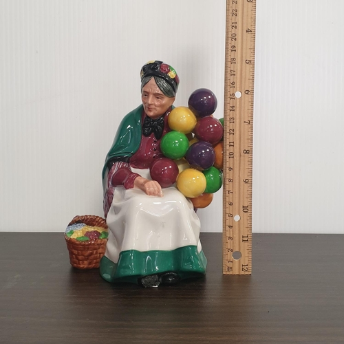 70 - Royal Doulton Porcelain Figure - The Old Balloon Seller. Height 18cm